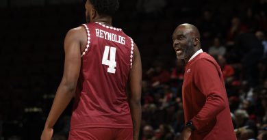 Jamile Reynolds (left) walks down the court as Aaron McKie (right) talks to him.