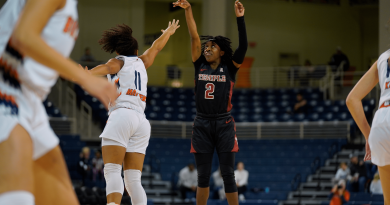 Senior guard Aleah Nelson shoots a jumper over the outstretched arms of her defender.