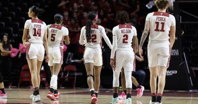 (Left to right) Ines Piper, Tiarra East, Tarriyonna Gary, Aleah Nelson, and Caranda Perea walk down the floor.