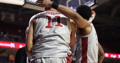 Damian Dunn embraces Nick Jourdain under the basket.