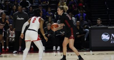 Caranda Perea Holds the ball at the top of the key and looks to make a pass.