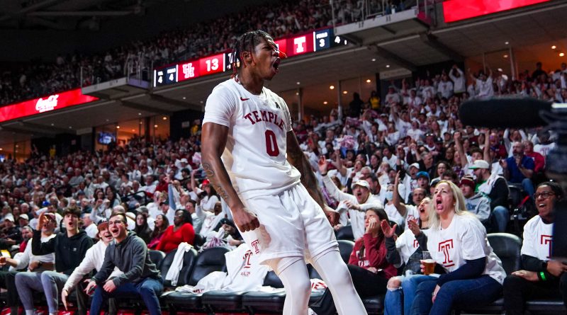 Khalif Battle celebrates a made three as the fans behind him erupt.
