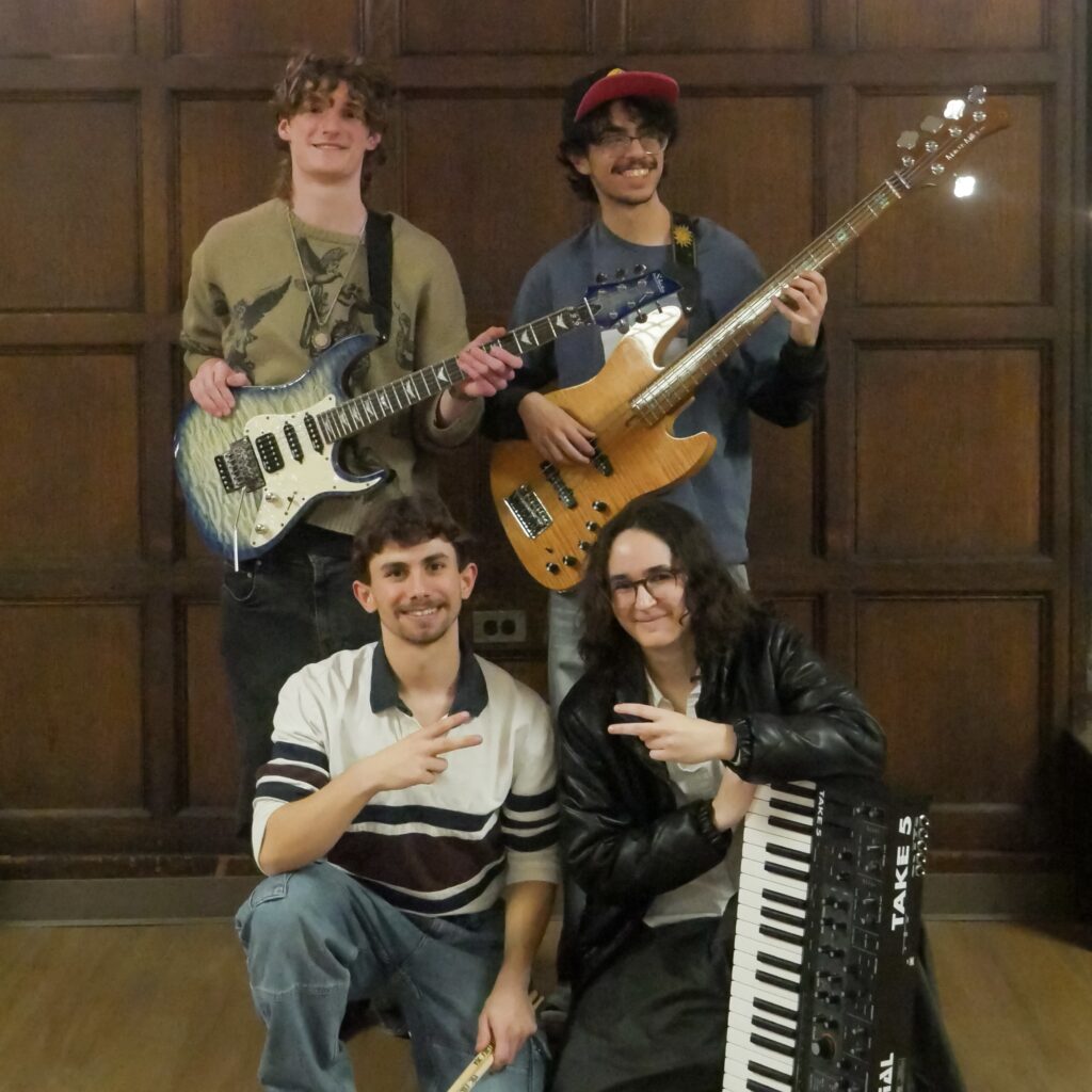 Paratopia's guitarist, bassist, keyboardist, and drummer posing with their instruments.